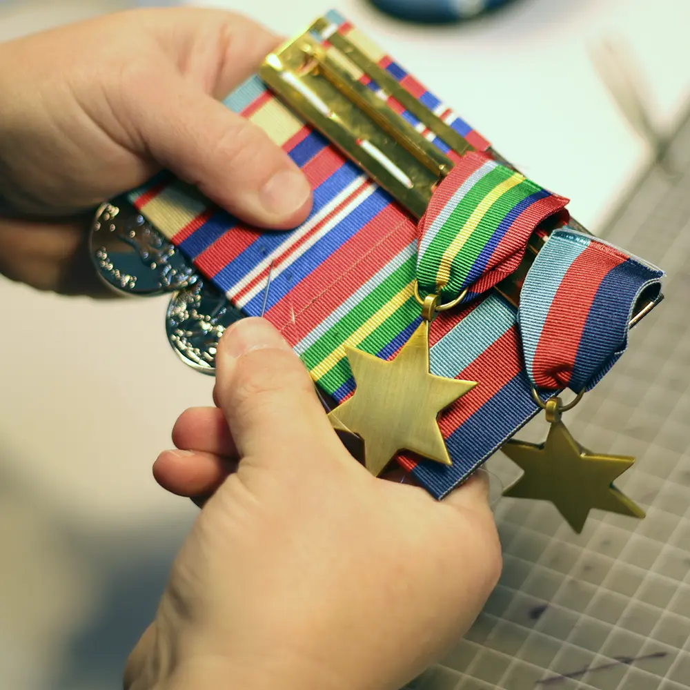 Court mounting medals by hand at the Rack Builder workshop
