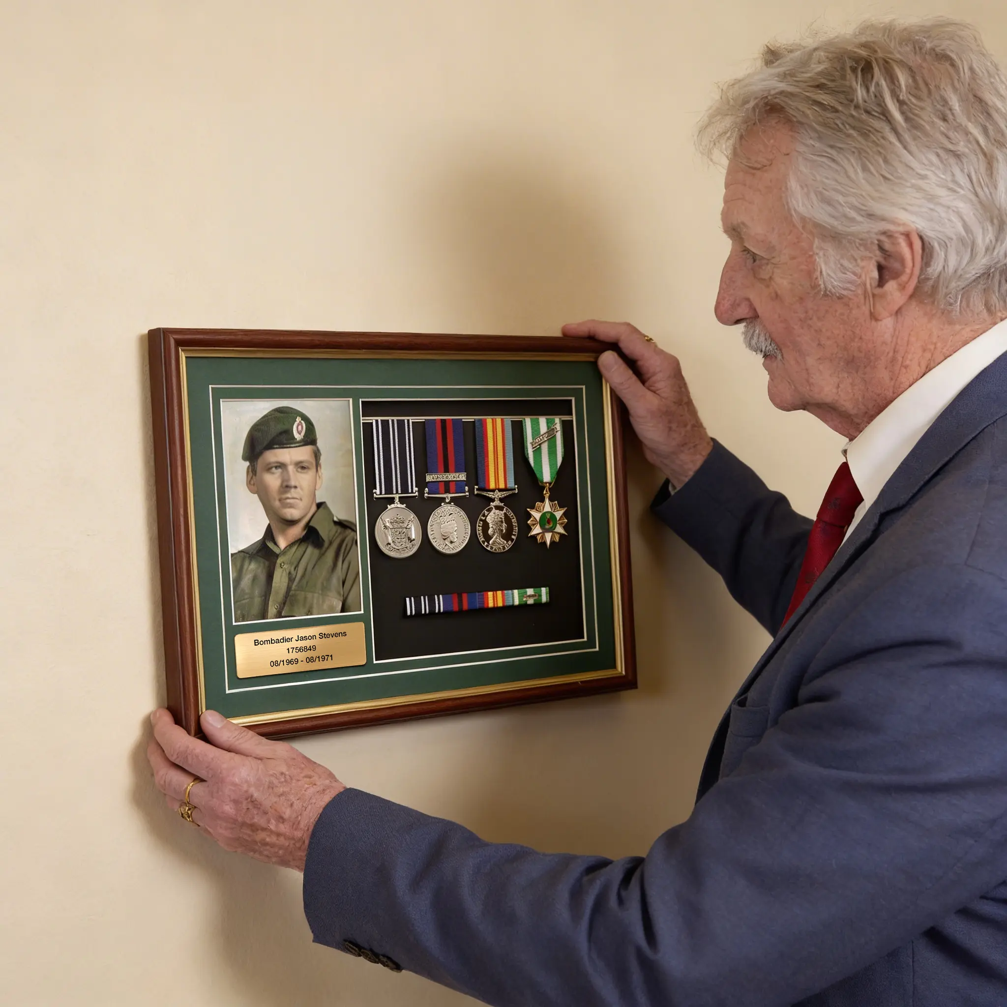 Service medals mounted in a timber photo frame with a photograph